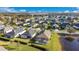 Aerial view showcasing a community with ponds, manicured lawns, and screened-in pools at 3831 Creekside Park Dr, Parrish, FL 34219