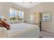 Cozy bedroom with decorative furniture, soft carpet and a view to the lush backyard at 3831 Creekside Park Dr, Parrish, FL 34219