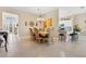 Inviting dining room with elegant chandelier, stylish furnishings, and a view to the kitchen area at 3831 Creekside Park Dr, Parrish, FL 34219