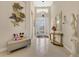 Bright and welcoming foyer featuring high ceilings, decorative art, and a charming console table at 3831 Creekside Park Dr, Parrish, FL 34219