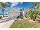 Inviting single-Gathering home featuring a lush front yard, palm trees, and a spacious driveway at 3831 Creekside Park Dr, Parrish, FL 34219