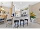 Open kitchen with bar stool seating, bright countertops, and views into the dining room at 3831 Creekside Park Dr, Parrish, FL 34219