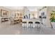 Bright kitchen with granite counters, backsplash, stainless appliances, seating, and adjacent dining area at 3831 Creekside Park Dr, Parrish, FL 34219
