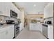 Modern kitchen features white cabinetry, granite counters, mosaic backsplash, and stainless appliances at 3831 Creekside Park Dr, Parrish, FL 34219