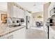 Open kitchen featuring stainless appliances, white cabinets, granite countertops, and adjacent dining area at 3831 Creekside Park Dr, Parrish, FL 34219