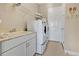 Bright laundry room with a sink, washer, dryer and storage at 3831 Creekside Park Dr, Parrish, FL 34219