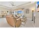 Comfortable living room featuring a cozy sectional, stylish decor, and a view to the patio at 3831 Creekside Park Dr, Parrish, FL 34219