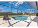 Relaxing screened pool with patio seating and a manicured backyard at 3831 Creekside Park Dr, Parrish, FL 34219