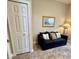 Cozy sitting area featuring a dark sofa with decorative pillows and a framed picture on the wall at 3831 Creekside Park Dr, Parrish, FL 34219
