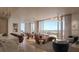 Open-concept living space boasts a spacious layout, hardwood floors, and access to a large outdoor patio at 550 Golden Gate Point # 701, Sarasota, FL 34236