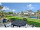 Relaxing backyard featuring a patio, green lawn, and canal views, perfect for outdoor entertaining and enjoying waterfront living at 585 Cutter Ln, Longboat Key, FL 34228