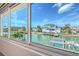 Expansive view of a coastal neighborhood and canal with boat docks from inside the home at 585 Cutter Ln, Longboat Key, FL 34228