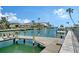 Picturesque canal view showcasing a private dock with seating, tropical landscaping, and serene waterfront living at 585 Cutter Ln, Longboat Key, FL 34228