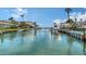 Scenic canal view showcasing waterfront homes, docks, and lush tropical landscaping, offering a tranquil and luxurious lifestyle at 585 Cutter Ln, Longboat Key, FL 34228