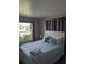 Relaxing bedroom with a comfortable queen-sized bed, and a pleasant view of the outdoors at 5876 Countrywood Dr, Sarasota, FL 34232