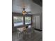 Bright dining area with neutral decor, a ceiling fan and a view of the surrounding landscape at 5876 Countrywood Dr, Sarasota, FL 34232