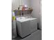 Bright laundry room with newer washer and dryer at 5876 Countrywood Dr, Sarasota, FL 34232