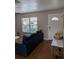 Cozy living room featuring a comfortable couch, hardwood floors, and ample natural light at 5876 Countrywood Dr, Sarasota, FL 34232