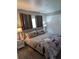 Comfortable main bedroom featuring a queen-sized bed, plush bedding, and ambient lighting at 5876 Countrywood Dr, Sarasota, FL 34232