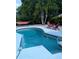 Relaxing backyard pool with seating and hammock in a tropical setting, perfect for outdoor enjoyment at 5876 Countrywood Dr, Sarasota, FL 34232