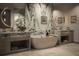 Spa-like bathroom with a freestanding tub, marble accents, and dual vanities for a luxurious experience at 590 Golden Gate Point # 905, Sarasota, FL 34236