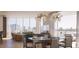 Modern dining area with city views, contemporary chandelier, and stylish furnishings for elegant entertaining at 590 Golden Gate Point # 905, Sarasota, FL 34236