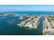 Stunning aerial view of waterfront home with private dock and pool, surrounded by beautiful ocean scenery at 624 N Point Dr, Holmes Beach, FL 34217