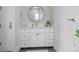 Clean bathroom design showing white vanity with many drawers and a round mirror at 624 N Point Dr, Holmes Beach, FL 34217