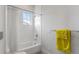 Bright bathroom features a shower-tub combo with white subway tile and a sunny window at 624 N Point Dr, Holmes Beach, FL 34217