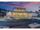 Beautiful two-story home with a luxurious pool, patio seating, and views of a colorful sunset at 624 N Point Dr, Holmes Beach, FL 34217