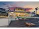 Spacious two-story home featuring a pristine pool, outdoor seating, and expansive views of the sunset at 624 N Point Dr, Holmes Beach, FL 34217