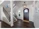 Inviting foyer with hardwood floors, staircase, and stylish lighting fixture at 624 N Point Dr, Holmes Beach, FL 34217