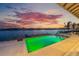 Pool and waterfront views offer an idyllic scene as the sun sets at 624 N Point Dr, Holmes Beach, FL 34217