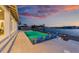 Inviting outdoor area featuring a sparkling pool, comfortable lounge chairs, and scenic waterfront views at 624 N Point Dr, Holmes Beach, FL 34217