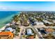 Aerial view of the turquoise beach house in a coastal community near the ocean at 912 N Shore Dr, Anna Maria, FL 34216