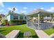 Charming backyard with a gazebo, lounge chairs, and well-manicured lawn with the turquoise beach house at 912 N Shore Dr, Anna Maria, FL 34216