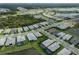 Aerial view of homes in the community, highlighting streetscape, pools, and lake views at 9978 Bright Water Drive, Englewood, FL 34223