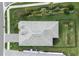 Aerial view of home's roof with a manicured lawn, landscaping, and paver driveway at 9978 Bright Water Drive, Englewood, FL 34223
