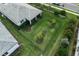 Aerial view of a home with backyard landscaping, lawn, screened lanai and neighborhood sidewalks at 9978 Bright Water Drive, Englewood, FL 34223