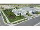 Aerial view of home with manicured lawn, landscaping, lake view and paver driveway at 9978 Bright Water Drive, Englewood, FL 34223