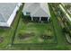 Aerial view of backyard with landscaped garden, dark metal fence and screened porch at 9978 Bright Water Drive, Englewood, FL 34223