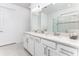 Spacious bathroom features double sinks with elegant fixtures, a large mirror, and ample counter space at 9978 Bright Water Drive, Englewood, FL 34223