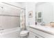Clean bathroom featuring a tiled shower/tub combo and white vanity with quartz countertop at 9978 Bright Water Drive, Englewood, FL 34223