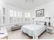 Bright bedroom with large windows, plantation shutters, and neutral-toned decor at 9978 Bright Water Drive, Englewood, FL 34223