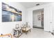 Cozy room features tile flooring, neutral color scheme, beach-themed artwork, and white armchair at 9978 Bright Water Drive, Englewood, FL 34223