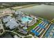 Aerial image featuring the resort-style pool, spa and recreational area by the lake at 9978 Bright Water Drive, Englewood, FL 34223