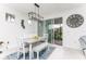 Dining area featuring tile floors, modern light fixture, sliding door access to the patio at 9978 Bright Water Drive, Englewood, FL 34223