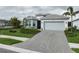 Lovely single-story home with a two-car garage, well-kept lawn, and attractive landscaping at 9978 Bright Water Drive, Englewood, FL 34223