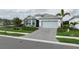 Beautiful single-story home with a paved driveway, manicured lawn, and well-maintained landscaping at 9978 Bright Water Drive, Englewood, FL 34223