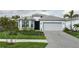 Charming single-story home featuring a two-car garage, tiled roof, and beautifully landscaped front yard at 9978 Bright Water Drive, Englewood, FL 34223